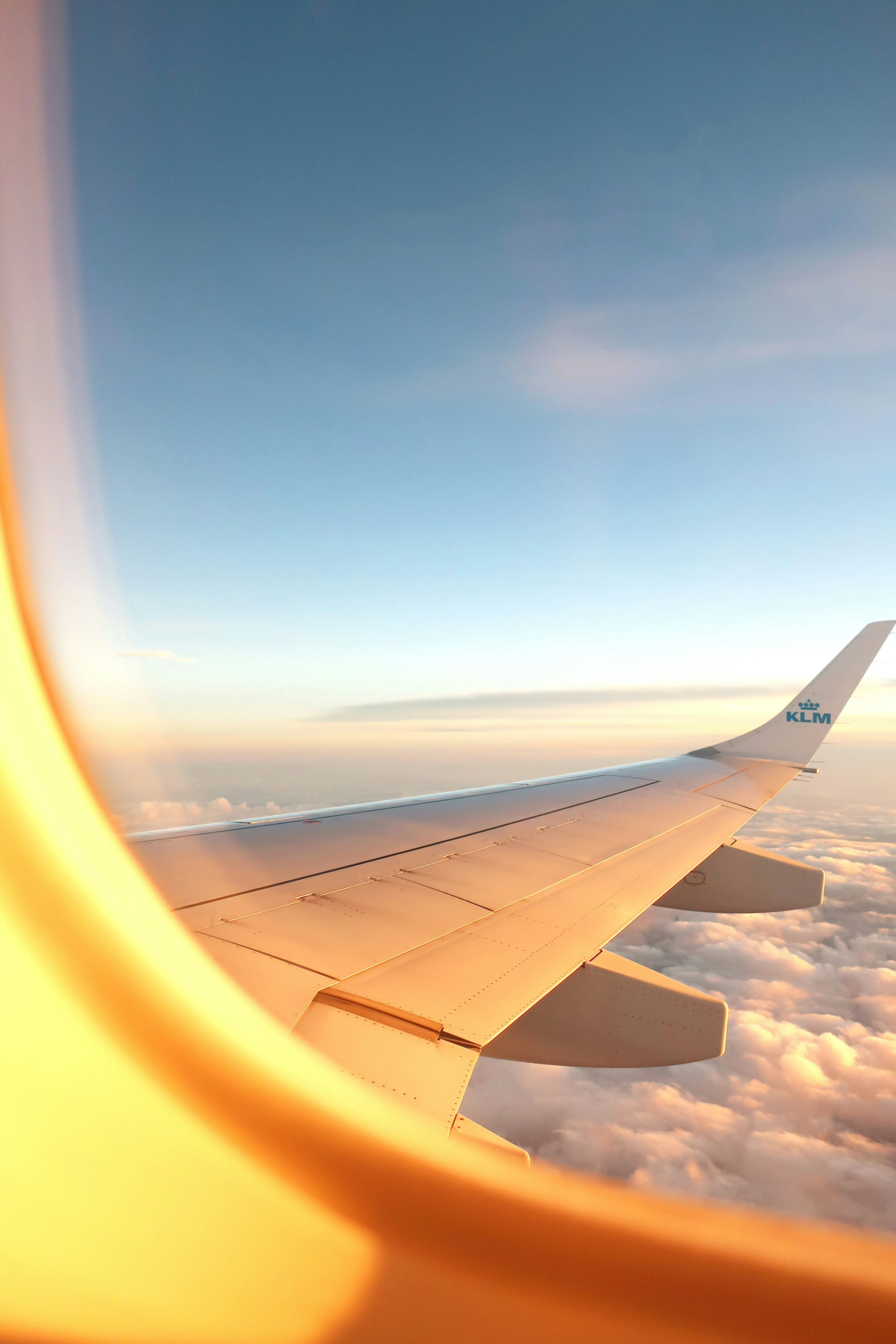 View of a plane wing and clouds from the window.